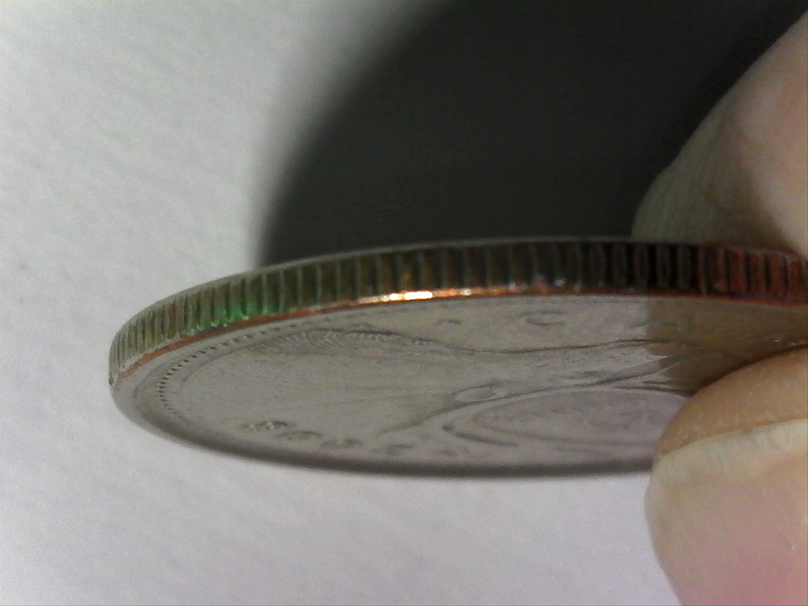 2008 25 ¢ with copper on edge.jpg